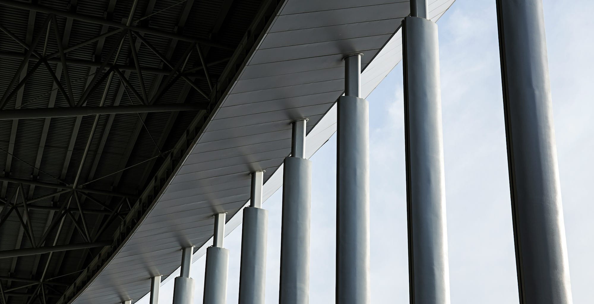grey concrete columns of building during daytime