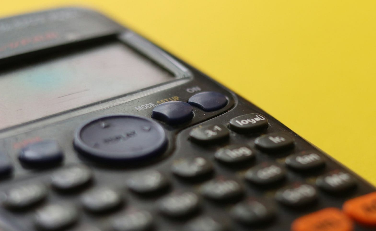 black remote control on yellow surface